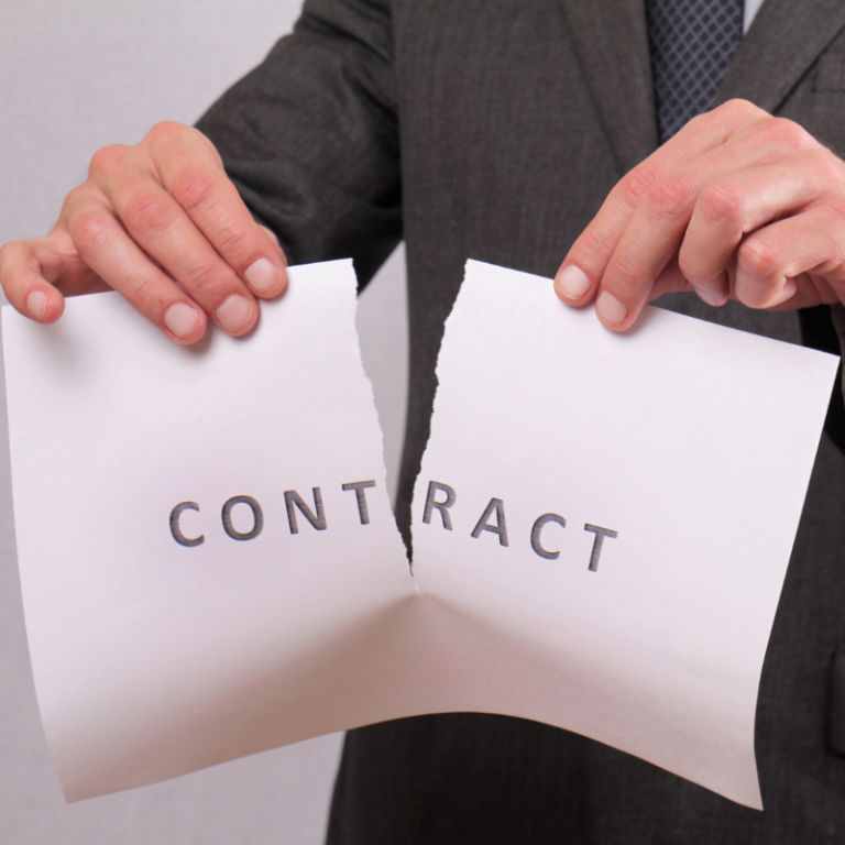 a man ripping a piece of paper that says the word contract